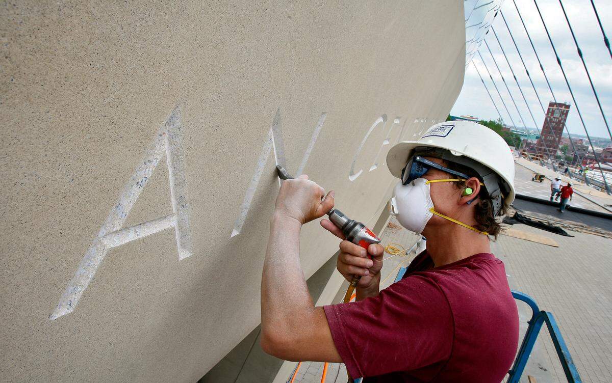 In 2011, a stone carver smoothed out the recessed areas of the individual letters of “Kauffman Center for the Performing Arts” on the front entrance of the new building.