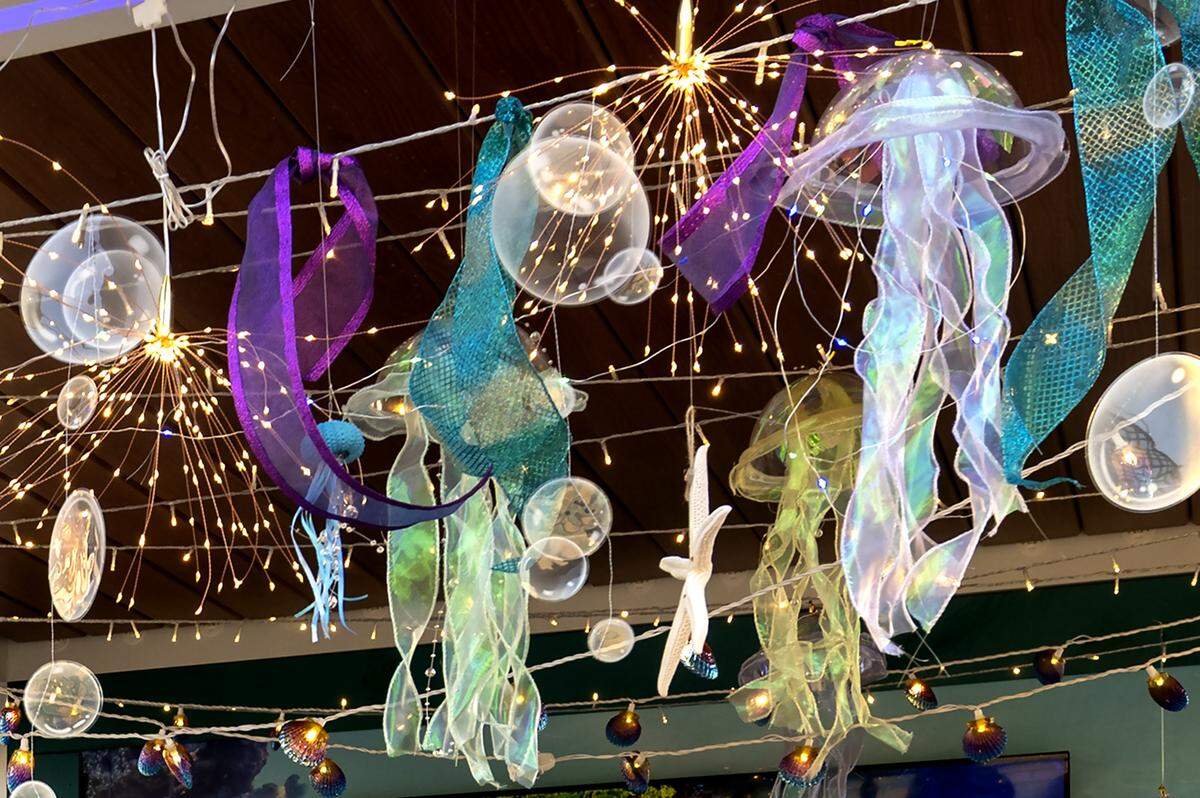 Festive decor including floating jellyfish adorn the Holiday at the Reef cabana on Monday, November 17, 2025, at Margaritaville Hotel Kansas City. The pop-up experience, The Frosted Cabanas, opens Wednesday, November 19, 2025.