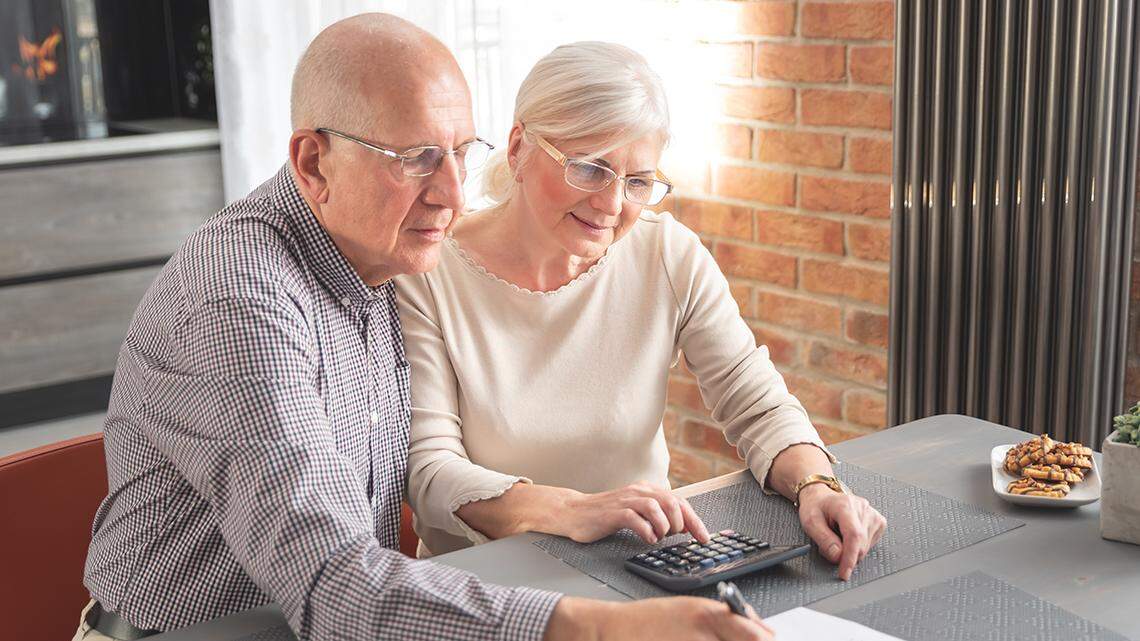 Retired senior couple checking and calculate financial billing. Financial paperwork, tax, increasing prices property tax income tax