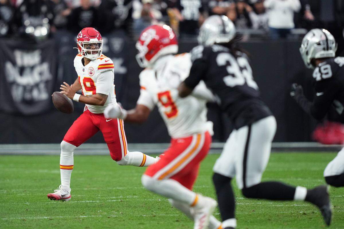 Kansas City Chiefs quarterback Chris Oladokun, left, scrambles against the Raiders’ defense during an NFL Week 18 game at Allegiant Stadum in Las Vegas on Sunday, Jan. 4, 2026.