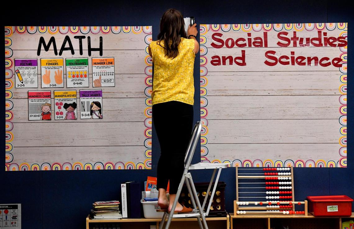 Fresh out of college, Brianna Kirk organizes her classroom at Countryside Elementary School in Olathe. The district brought students back to classrooms full-time earlier this month.