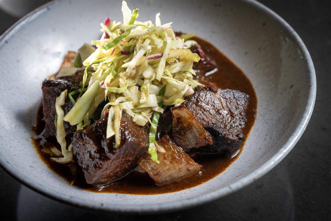Black Cardamom Burnt Ends, an entrée of cherrywood-smoked beef served over grits with a pickled fennel salad, on the menu at Of Course Kitchen & Co., 7753 W. 159th St. in Overland Park, on Wednesday, Feb. 25, 2026.