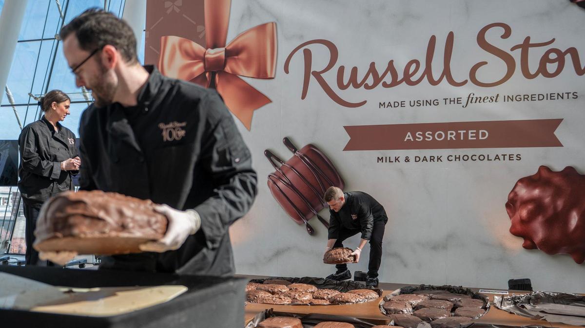 Russell Stover chocolatiers assort giant chocolate slabs into a huge box during Russell Stover Chocolates’ attempt to break the Guinness World Record for the largest box of chocolate.