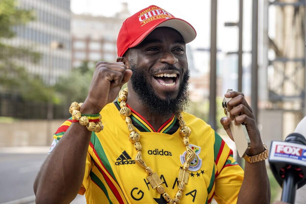 Thomas Afful celebrates during an interview while waiting for the Ghana national team outside the Sheraton Kansas City Hotel on Wednesday, July 1, 2026.