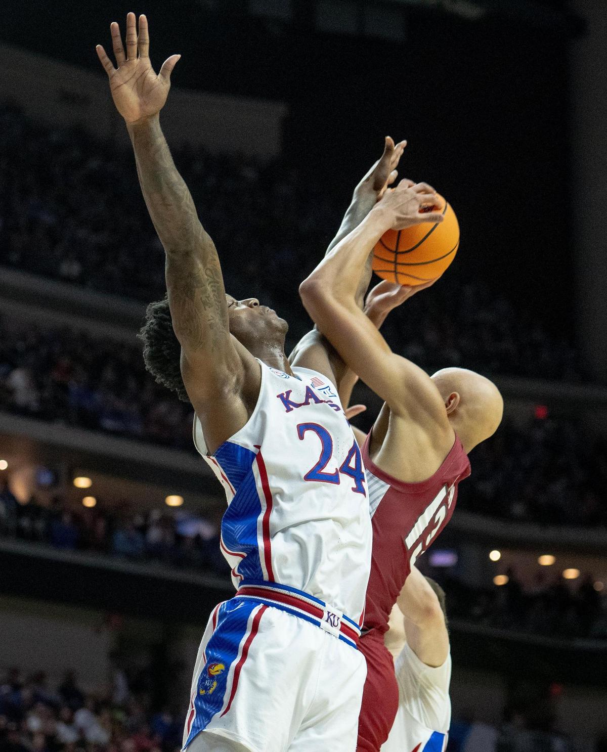 Kansas forward K.J. Adams Jr. (24) fouls Arkansas guard Jordan Walsh (13) during a second-round college basketball game in the NCAA Tournament Saturday, March 18, 2023, in Des Moines, Iowa.