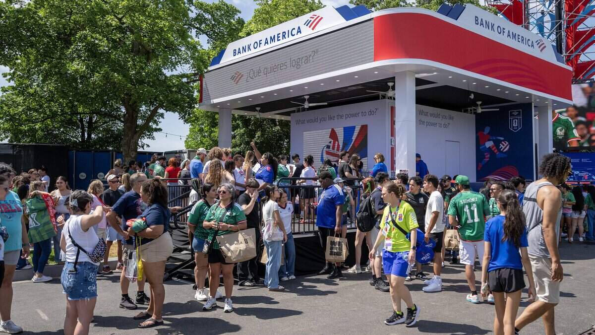 Fans stand in line to order drinks near the Bank of America booth while attending the FIFA Fan Festival on Thursday, June 11, 2026, in Kansas City.