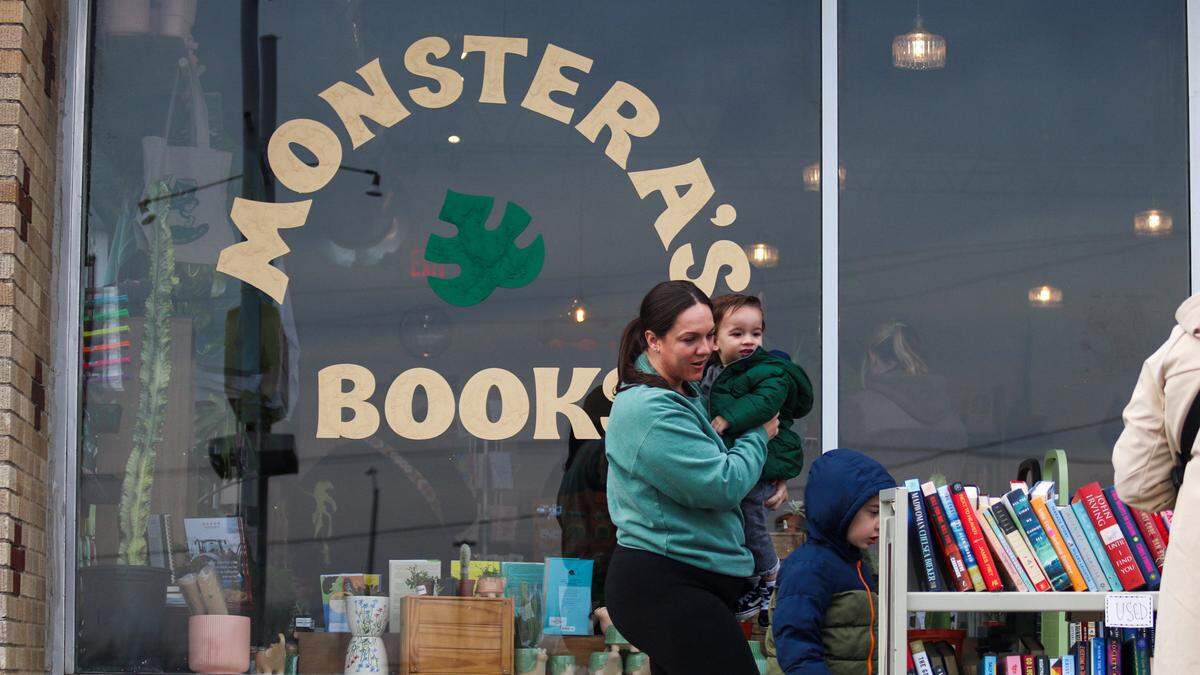 Meg Miller, 38, is seen with her two sons, Zayn and Amyr at Monstera’s Books in Overland Park at its reopening Dec. 6, 2025.