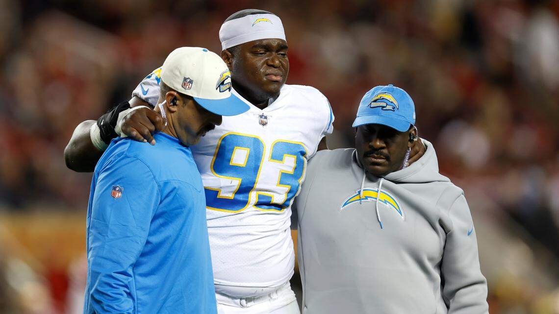 Los Angeles Chargers defensive tackle Otito Ogbonnia (93) is helped off the field during the first half of an NFL football game against the San Francisco 49ers in Santa Clara, Calif., Sunday, Nov. 13, 2022. (AP Photo/Jed Jacobsohn)