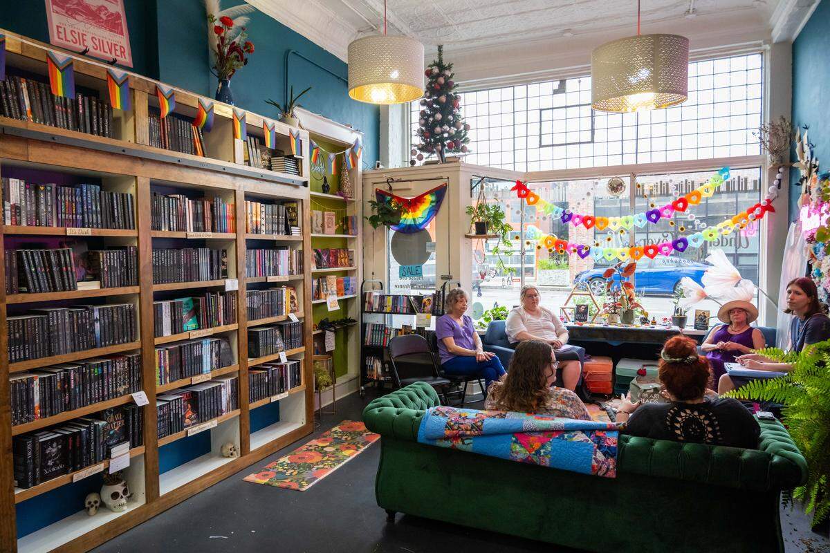 A book club met during Pride Month at Under The Cover, a romance bookshop in Kansas City.