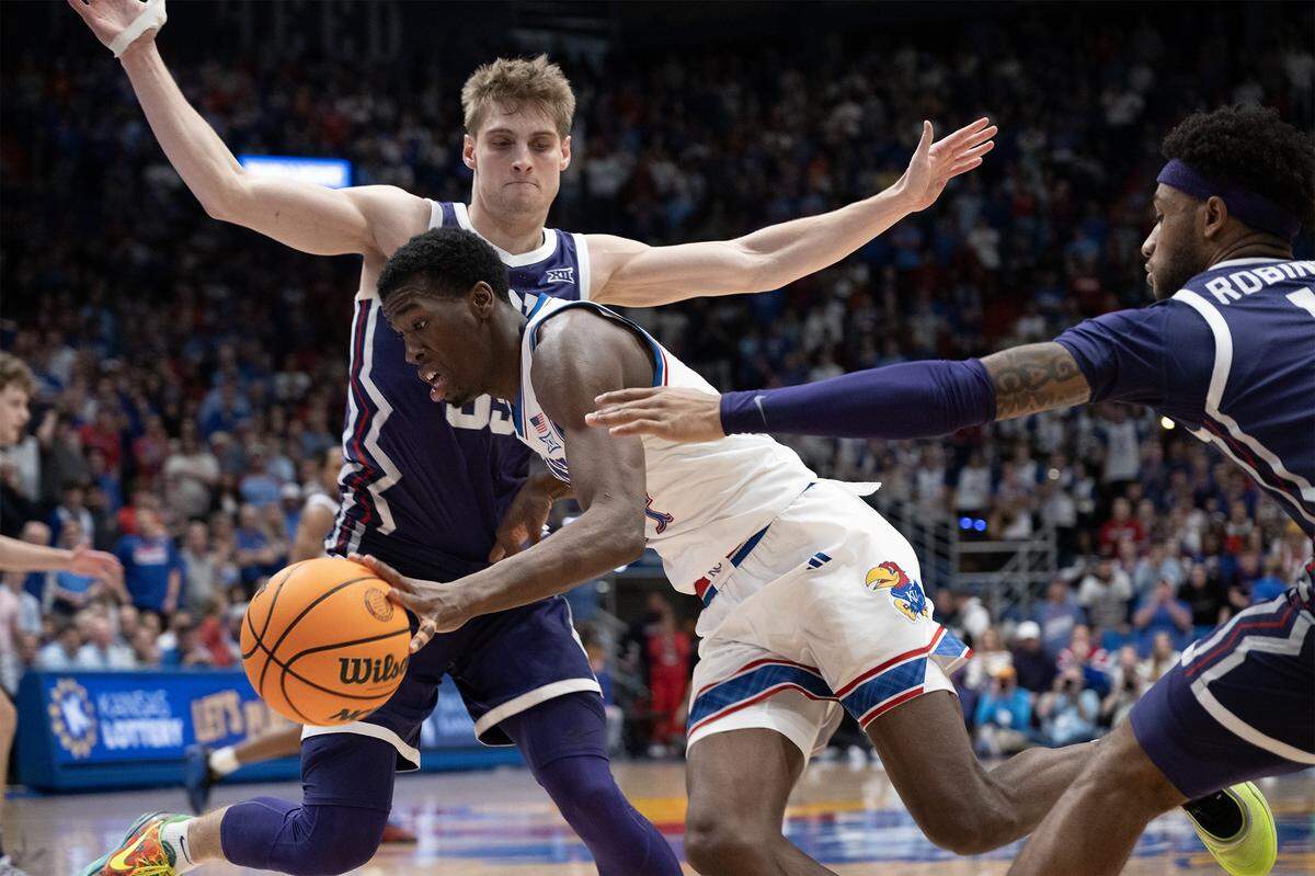 Kansas Jayhawks guard Melvin Council Jr. (14) drives past TCU Horned Frogs guard Tanner Toolson (55) in overtime at Allen Fieldhouse in Lawrence on Tuesday, Jan. 6, 2025.