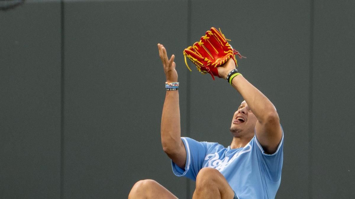 Kansas City Chiefs quarterback Patrick Mahomes sits on the ground as he prepares to catch a fly ball during the Big Slick celebrity softball game at Kauffman Stadium on Friday, June 2, 2023, in Kansas City.