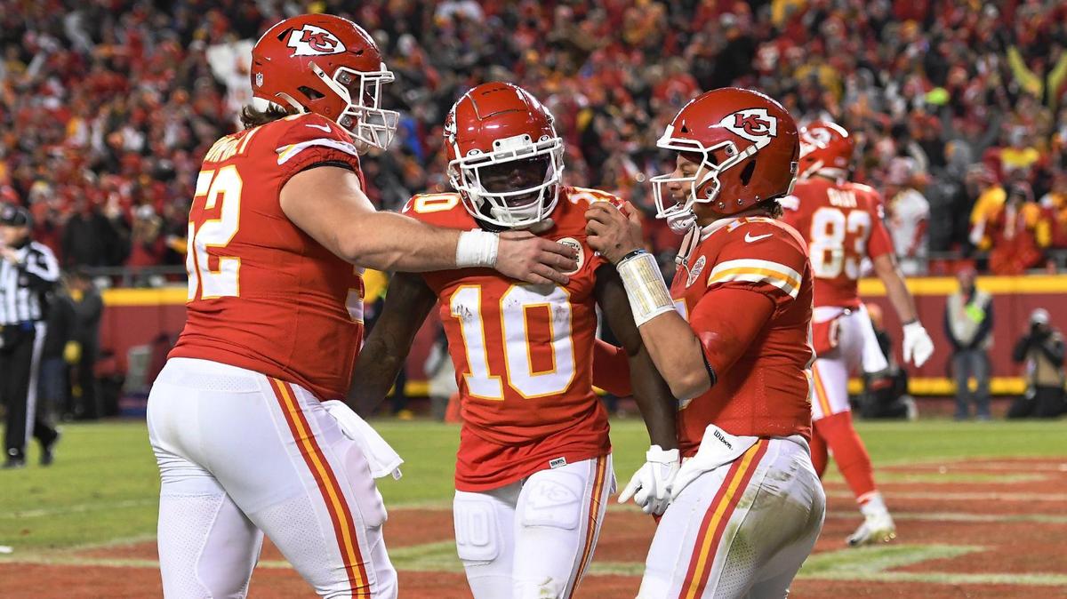 Kansas City Chiefs center Creed Humphrey. left, and quarterback Patrick Mahomes congratulate wide receiver Tyreek Hill after hill scoured on a 64-yard reception in the fourth quarter Sunday, January 23, 2022, at Arrowhead Stadium.