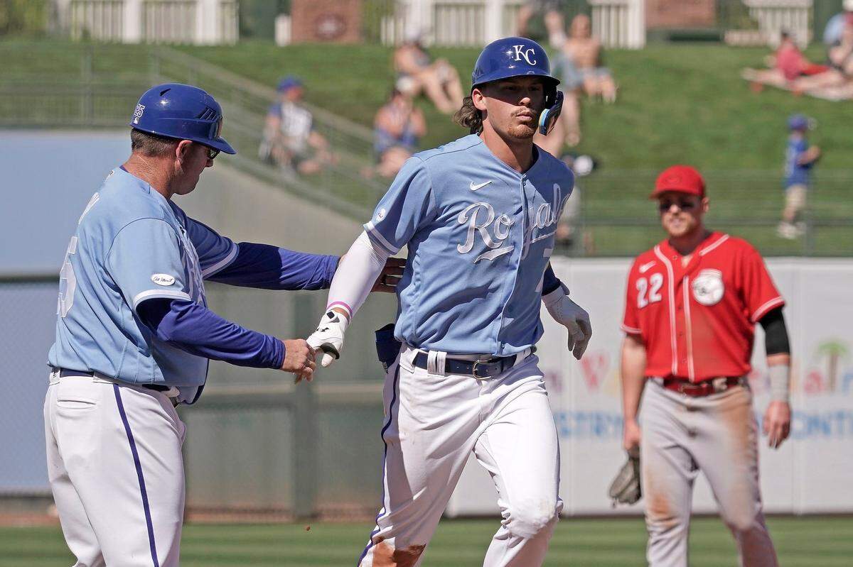 Kansas City Royals infielder Bobby Witt Jr., left, celebrates with third base coach Vance Wilson after hitting a three-run homer at spring training on Thursday in Surprise, Ariz.