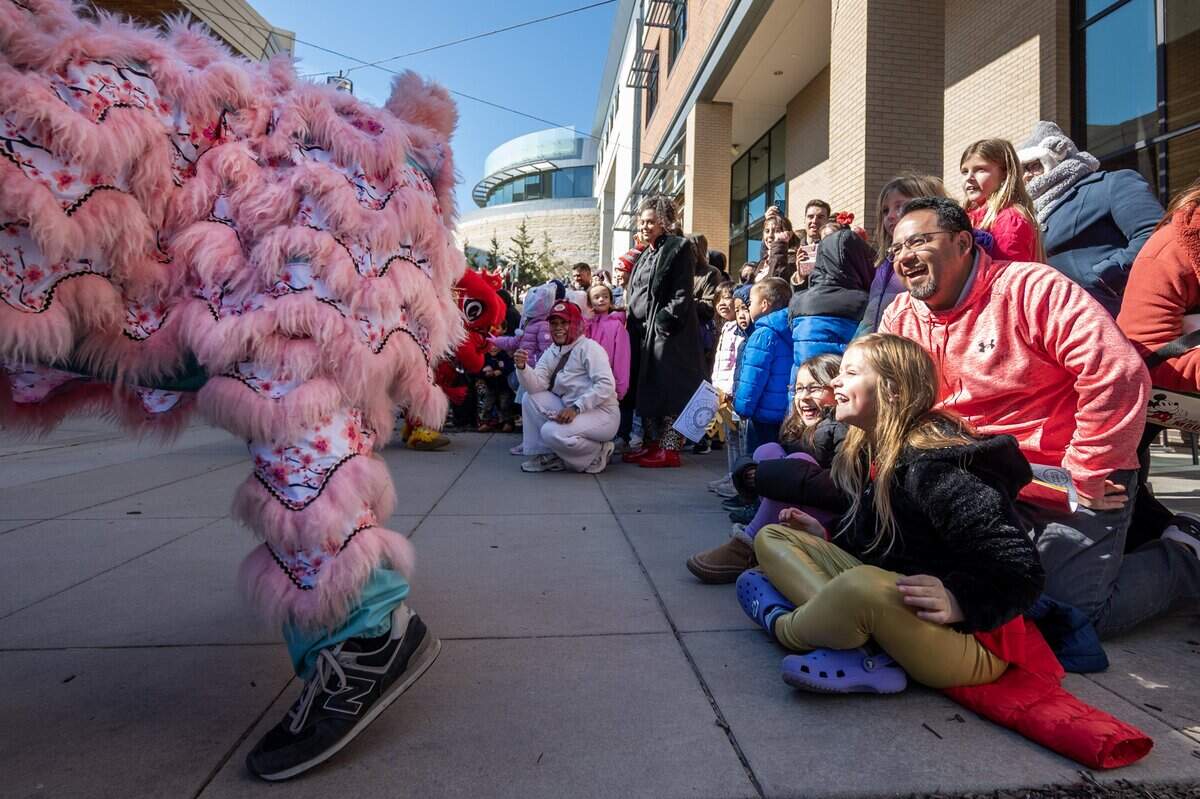 People laugh as the Th?n Phúc Lion Dance team perform at a Lunar New Year celebration at the Lenexa Public Market on Sunday, Feb. 22, 2026, in Lenexa.