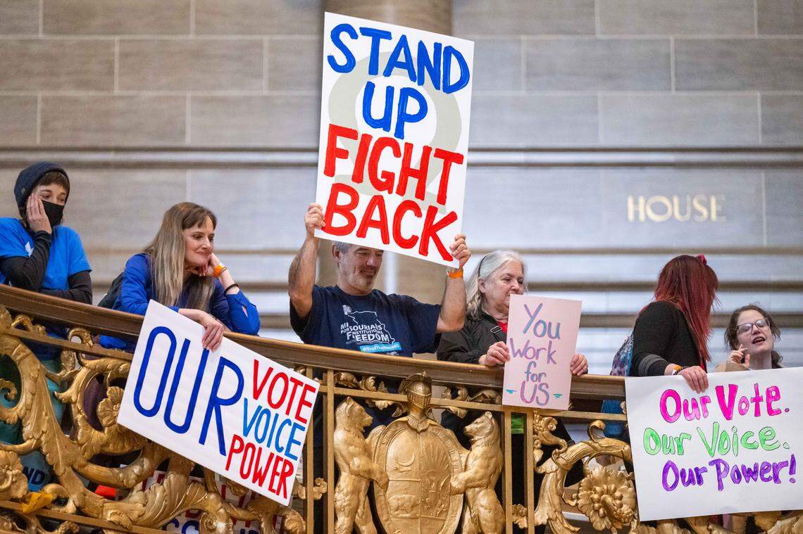 Protesters hold signs in the Missouri State Capitol rotunda on Wednesday, January 21, 2026 in Jefferson City. Organizations and allies gathered to protest recent Missouri lawmaker's decisions.