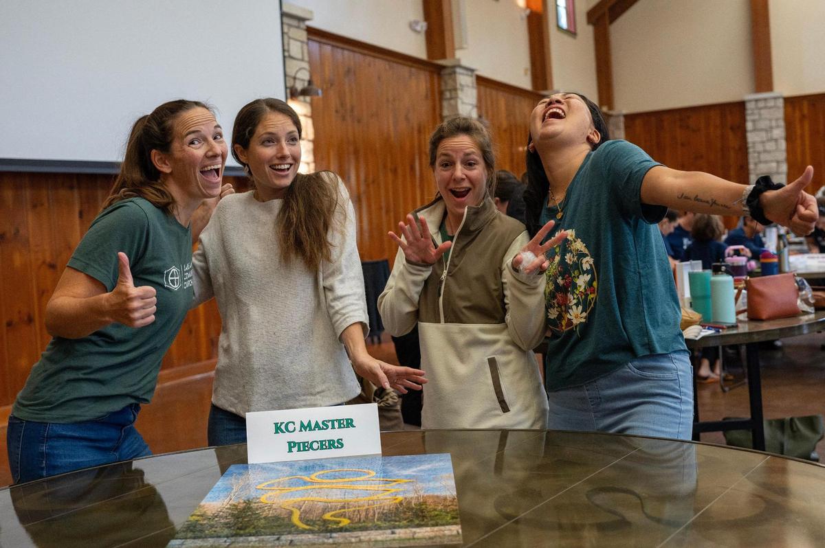 KC Master Piecers team members celebrate after finishing first in the Puzzle Palooza competition. The first-place team received a $150 cash prize.