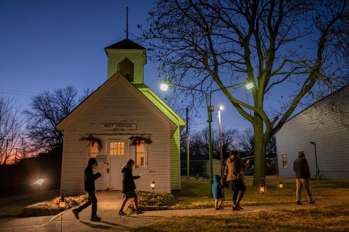 Visitors walk into Heritage Park during the St. Lucia Festival in Lindsborg.