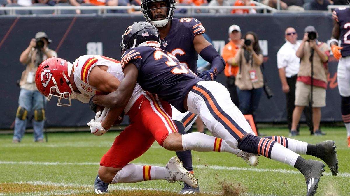 Draped by Bears defensive back Elijah Hicks, Chiefs wide receiver Justin Watson catches a touchdown pass from quarterback Shane Buechele during the first half Saturday at Soldier Field in Chicago.