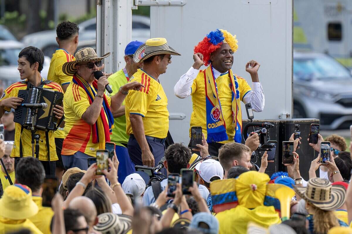 Kansas City Mayor Quinton Lucas wears a Colombia-themed wig while on stage during a Colombia banderazo at Mill Creek Park on Thursday, July 2, 2026, in Kansas City.