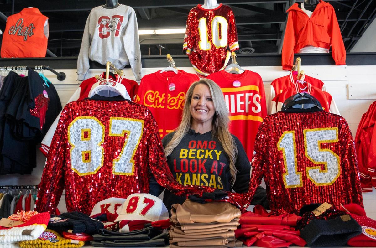 Owner Melissa Wassergord among a display of Chiefs-themed clothing she designed and sells at her store, Maxi Laine’s Boutique.