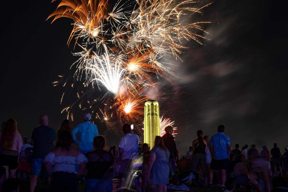 People watch and record fireworks from the North Lawn of the National World War I Museum and Memorial at the end of the Celebration at the Station, an event featuring the Kansas City Symphony to celebrate and commemorate Memorial Day on Sunday, May 29, 2022, in Kansas City.