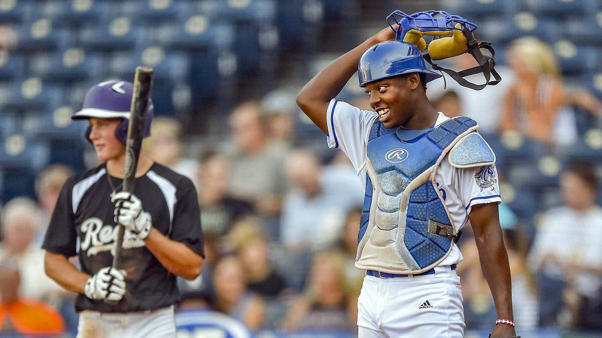 Blue Springs South catcher Allante Hall smiles during the third inning of last summer's Ban Johnson Baseball League All-Star Game at Kauffman Stadium.