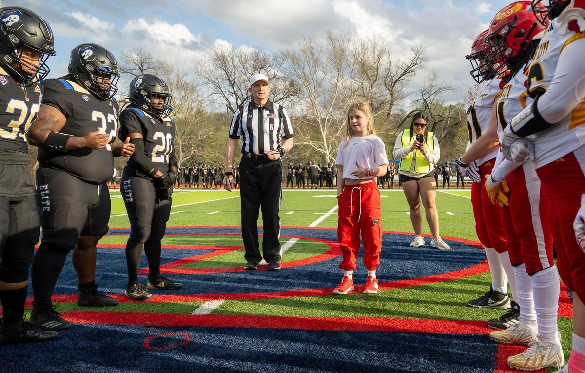 Elena Easley, an 8-year-old from Cambridge, Minnesota, does the coin toss for the home opener for the Kansas City Glory, right, the city’s semi-professional women’s full-contact tackle football team, who took on Texas Elite, left, on Saturday, March 29, 2025, at the Pembroke Hill School in Kansas City.