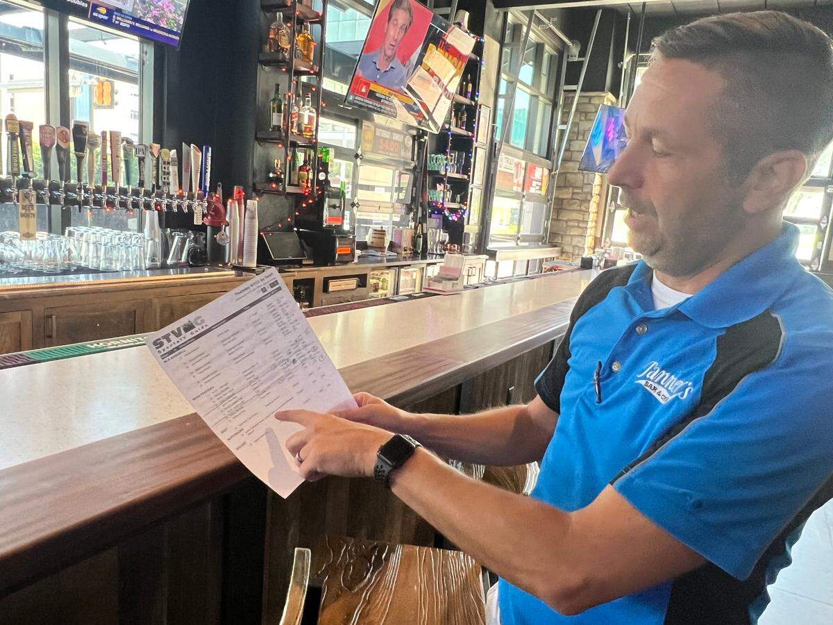 Dan Isenberg, manager at the Tanner’s Bar & Grill at 39th Street and Rainbow Road in Kansas City, Kansas, displays the stations he is programming Thursday in anticipation for the big crowd he expects to watch the University of Missouri football season opener.