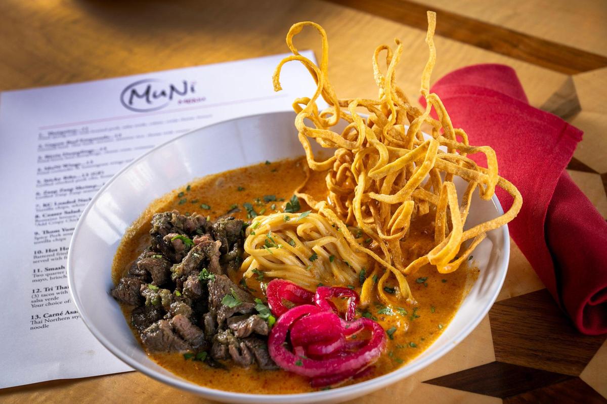Carne’ Asada Kow Soi, $22, a Thai Northern-style coconut curry with carne asada steak, cilantro, scallion, pickled shallot and crispy egg noodles.