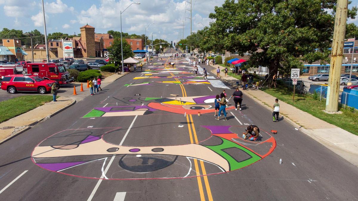 Artists and volunteers work on a giant Black Lives Matter mural at 63rd St. and Troost Ave. Saturday, Sep. 5, 2020. Six unique Black Lives Matter murals were painted at the same time across the Kansas City.