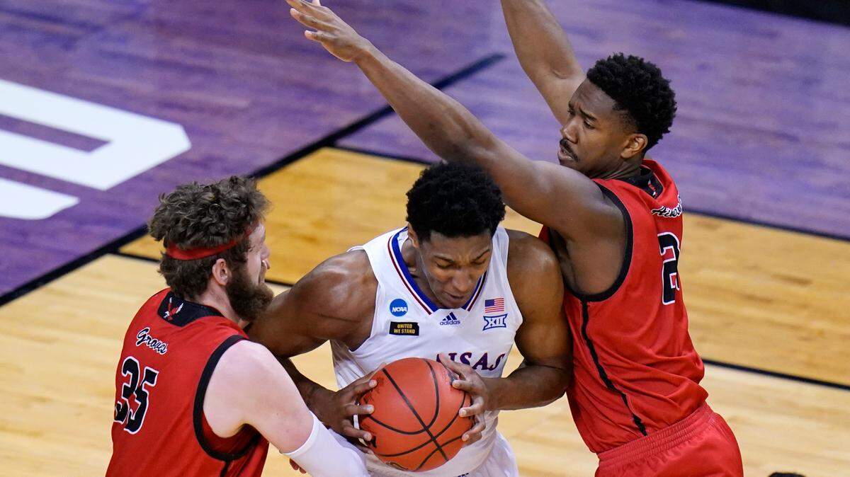 Eastern Washington forward Tanner Groves (35) and teammate Kim Aiken Jr., left, pressure Kansas forward David McCormack, center, during the second half of a first-round game in the NCAA college basketball tournament at Farmers Coliseum in Indianapolis, Saturday, March 20, 2021. (AP Photo/AJ Mast)