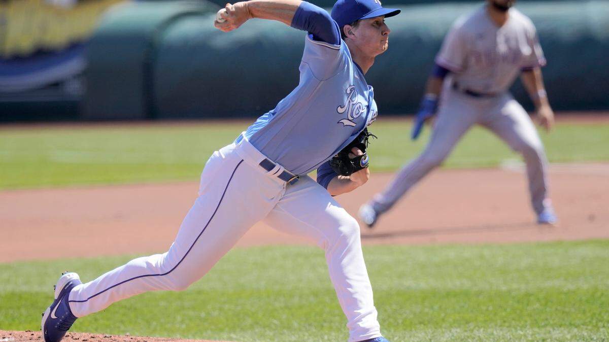 Kansas City Royals starting pitcher Brady Singer delivers to a Texas Rangers batter during the first inning of a baseball game at Kauffman Stadium in Kansas City, Mo., Sunday, April 4, 2021. (AP Photo/Orlin Wagner)