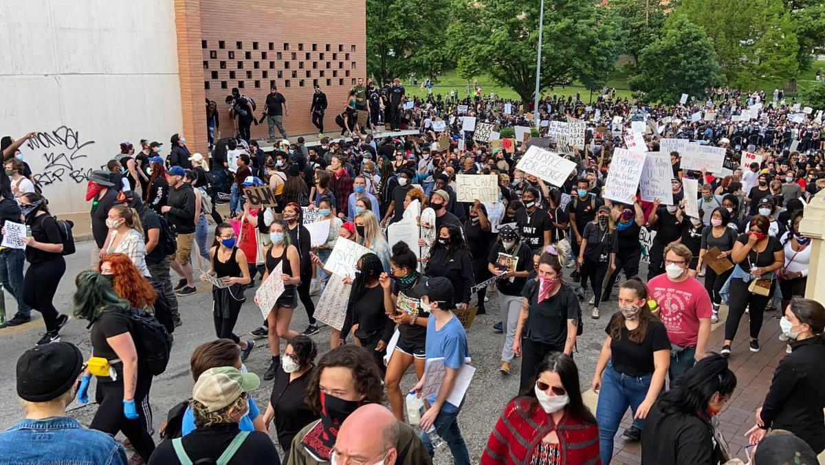 Protesters sound off Saturday at the Country Club Plaza during a protest to bring awareness to the death of George Floyd who died in the custody of Minneapolis police. The protest turned violent later in the night when stores on the Plaza were vandalized and at least one police car was set on fire. Police used tear gas in an attempt to control the crowd.