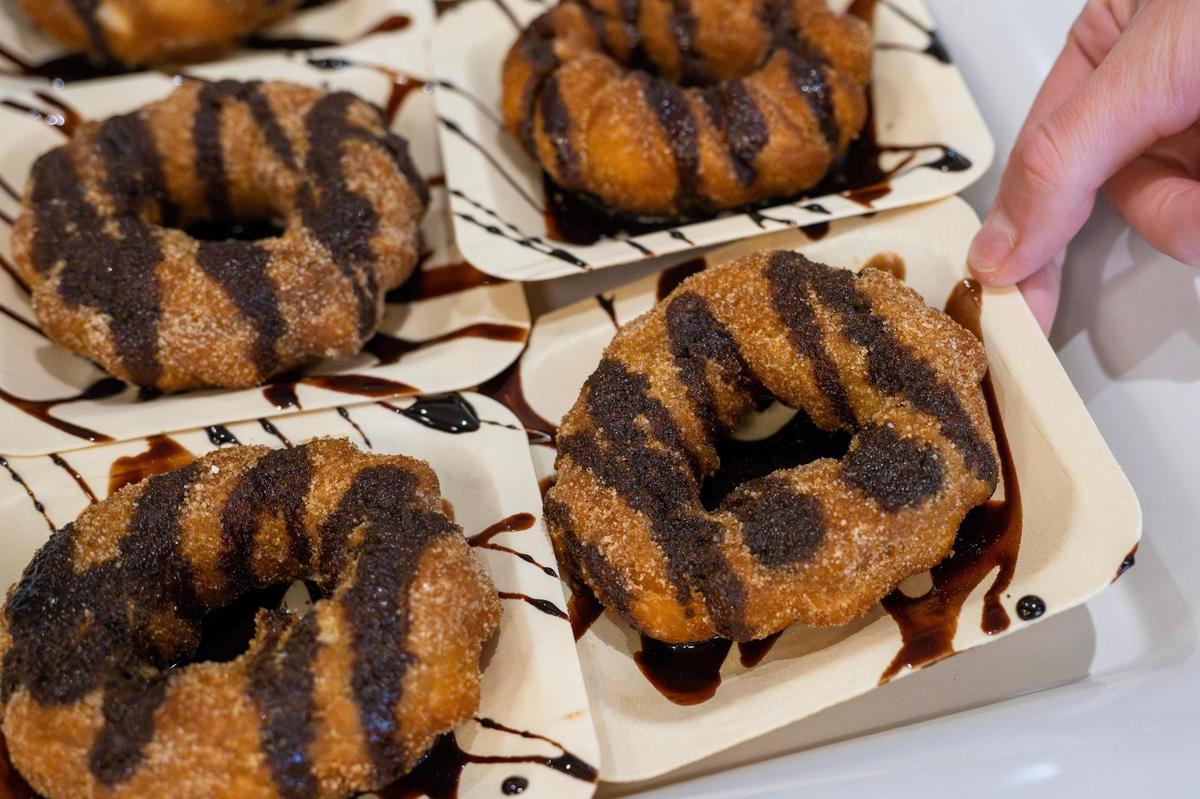 A churro glazed with chocolate is served during the Escape Lounge grand opening at Kansas City International Airport on Thursday, April 3, 2025.