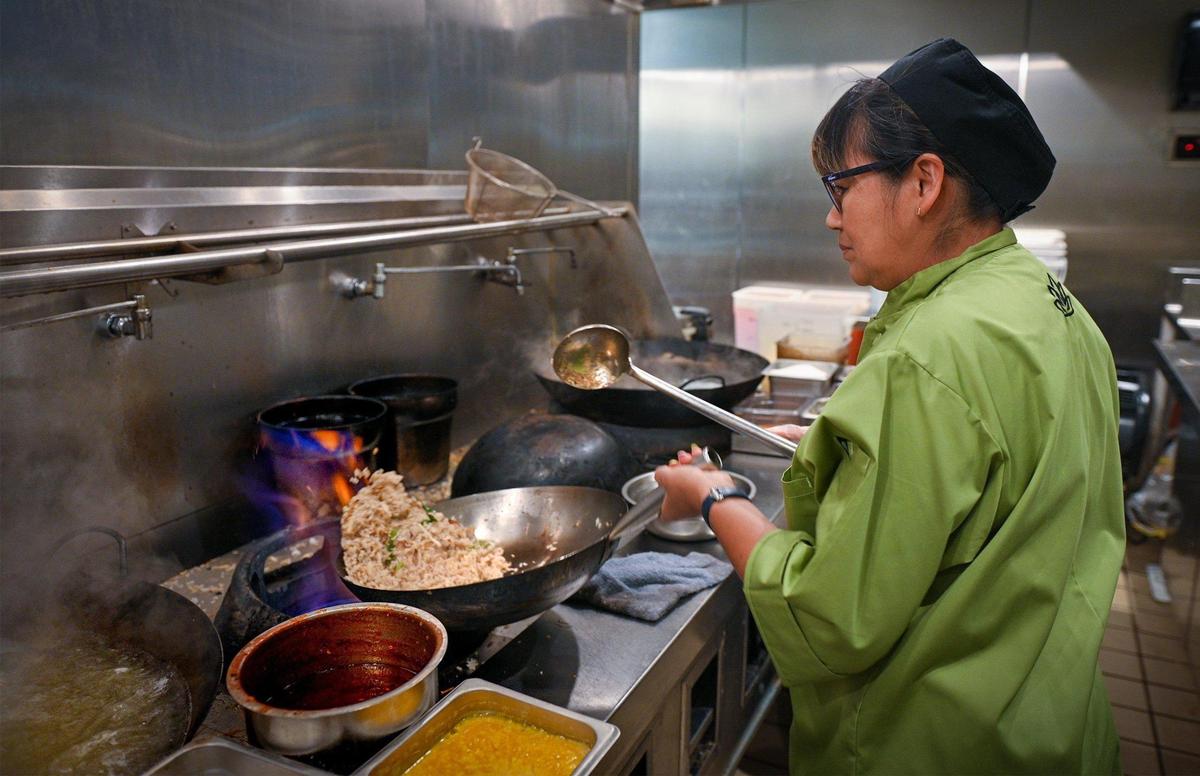 Co-owner and Chef Penny Mufuka cooks up a chicken fried rice in the kitchen at Bamboo Penny’s, a new Thai restaurant she opened with her husband Doug Mufuka in Leawood’s Park Place.