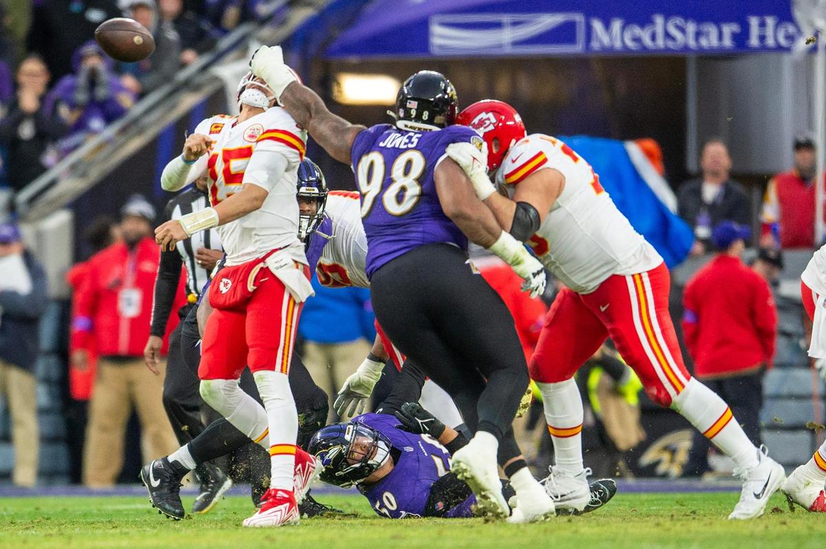 Kansas City Chiefs quarterback Patrick Mahomes (15) is hit by Baltimore Ravens defensive tackle Travis Jones (98) in the second quarter during the AFC Championship Game at M&T Bank Stadium on Sunday, Jan. 28, 2024, in Baltimore.