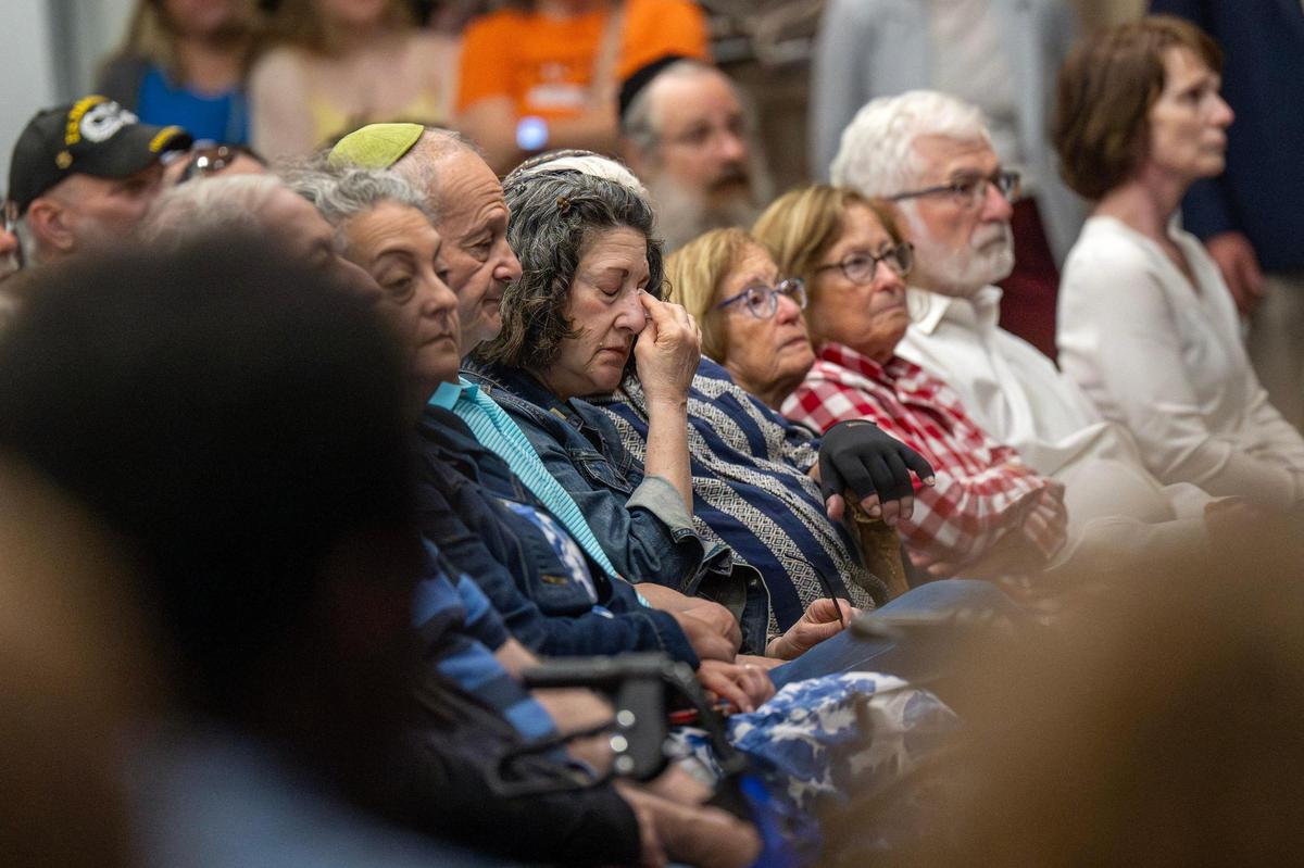 A mourner wipes away tears during a vigil for Sarah Milgrim and Yaron Lischinsky at the Jewish Community Center’s Social Hall on Thursday, May 22, 2025, in Overland Park. Milgrim and Lischinsky were killed outside the Capital Jewish Museum in Washington, D.C., on Wednesday, May 21.