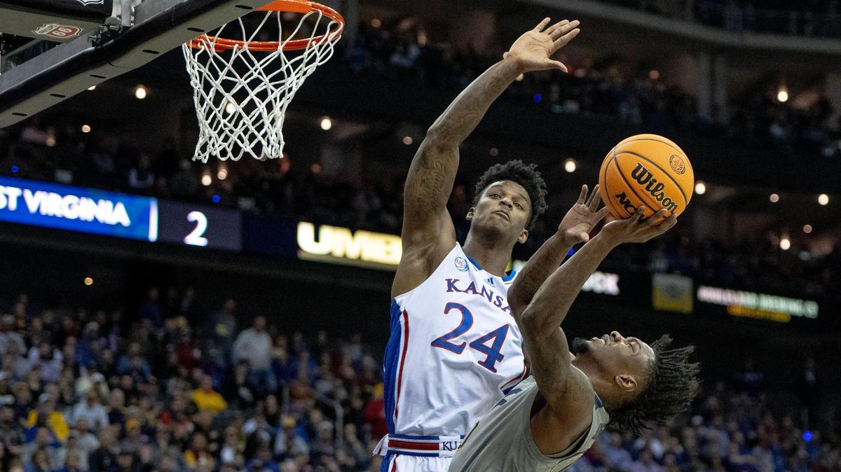 Kansas forward K.J. Adams Jr. (24) contests a shot by West Virginia guard Kedrian Johnson (0) during a second-round game in the Big 12 Tournament Thursday, March 9, 2023, in Kansas City.