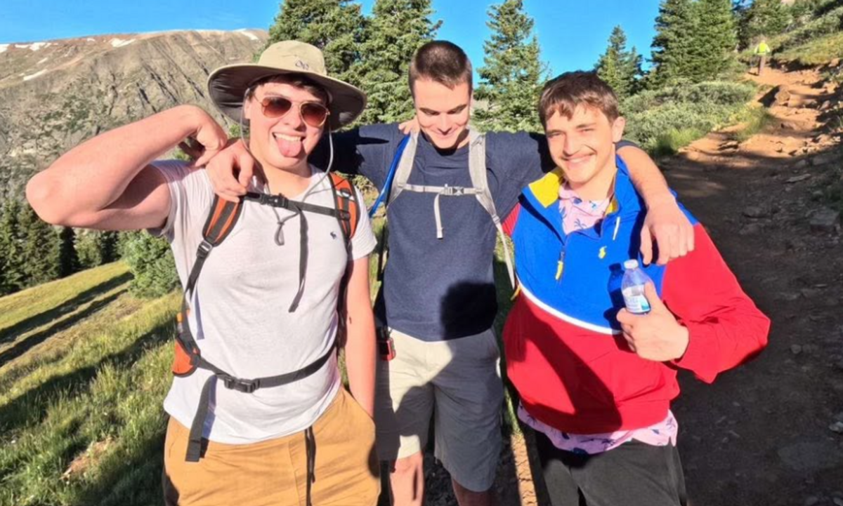 Will Fischer (right) poses with friends on a vacation.
