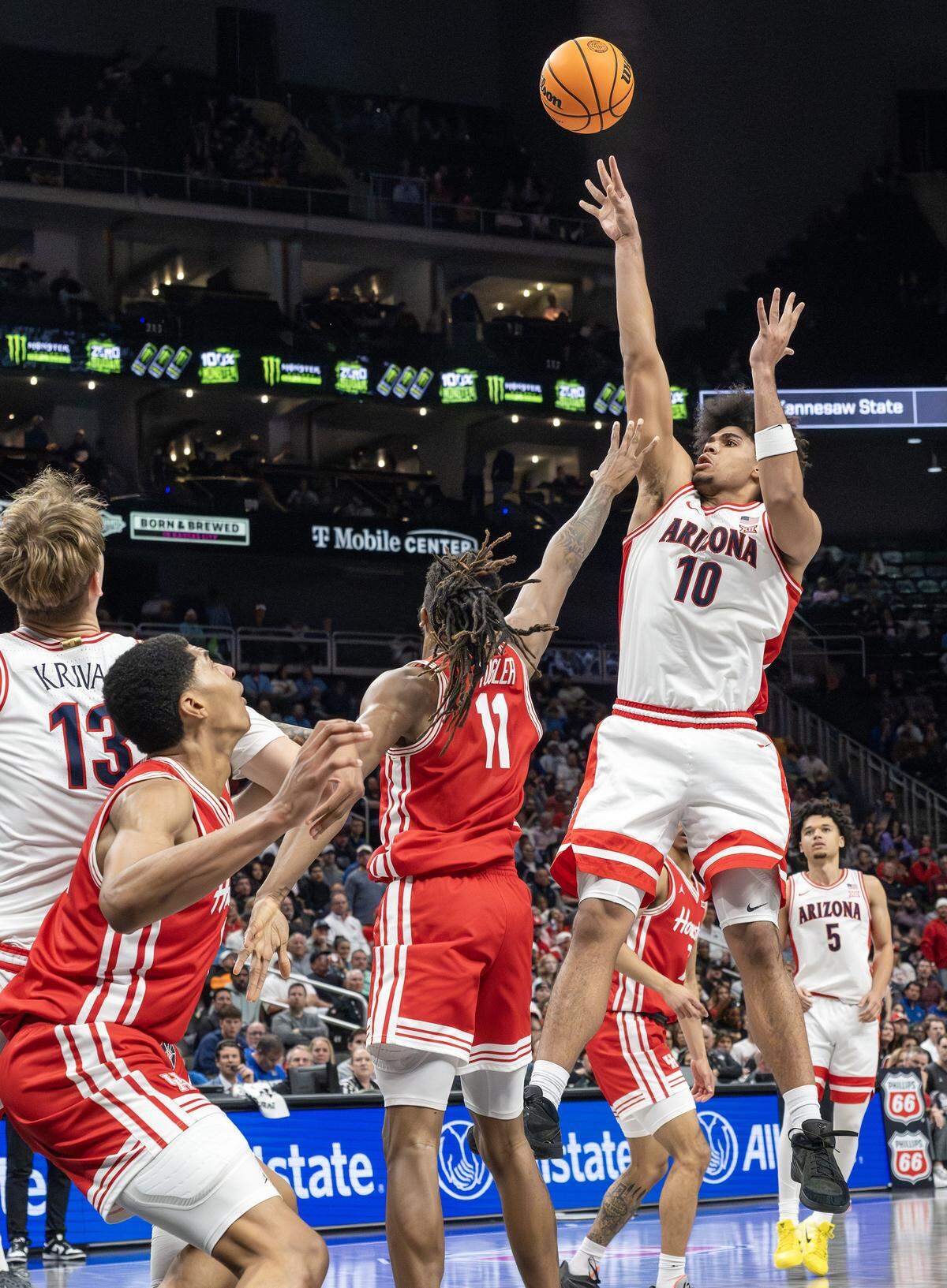Arizona Wildcats forward Koa Peat (10) shoots a basket over Houston Cougars forward Joseph Tugler (11) during the second half of the Big 12 Men's Basketball Tournament Championship game at T-Mobile Center on Saturday, March 14, 2026, in Kansas City.