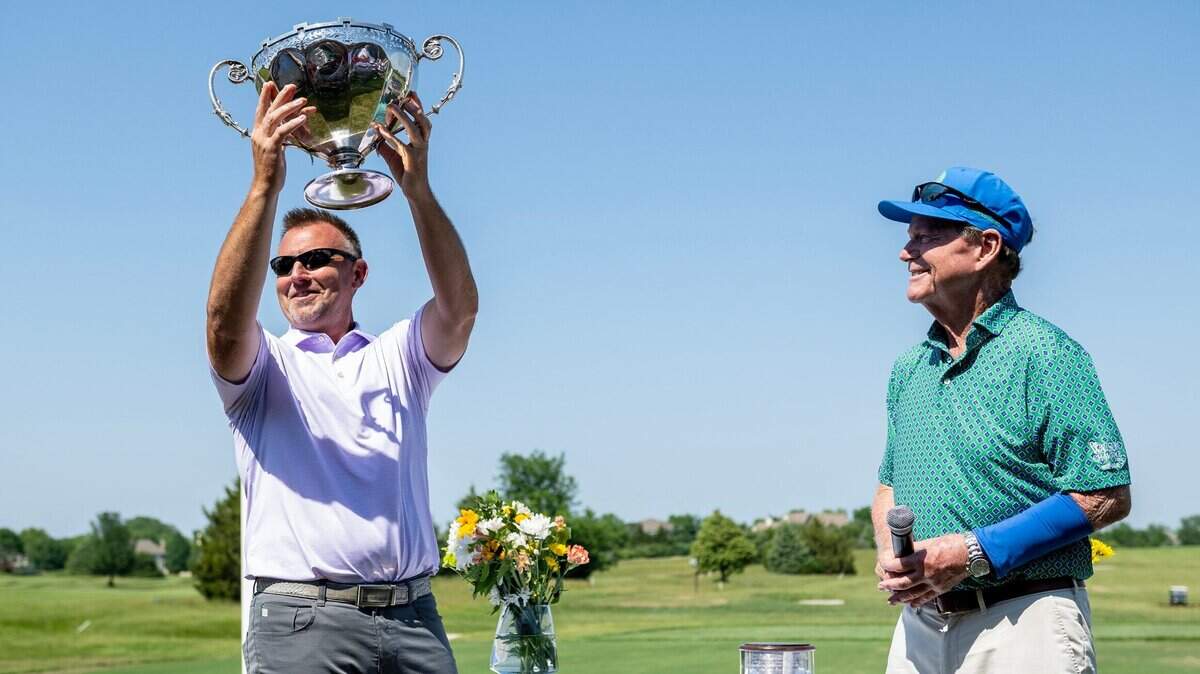 Retired PGA Tour golfer Tom Watson (right) watches Robert Russell hoist the Watson Challenge tournament trophy at Nicklaus Golf Club on Saturday, June 3, 2023, in Overland Park.