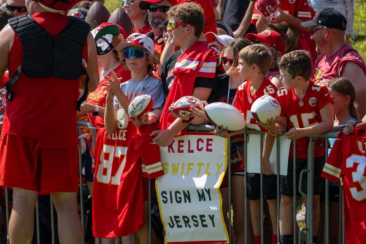 Kansas City Chiefs fans wait for players to sign autographs after practice at Chiefs training camp.