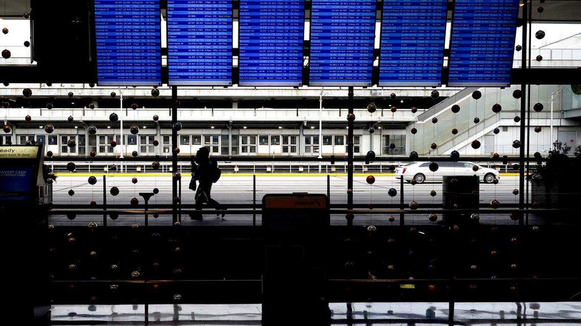Travelers walk through Terminal 3 at O’Hare International Airport in Chicago, Sunday, Nov. 29, 2020. (AP Photo/Nam Y. Huh)