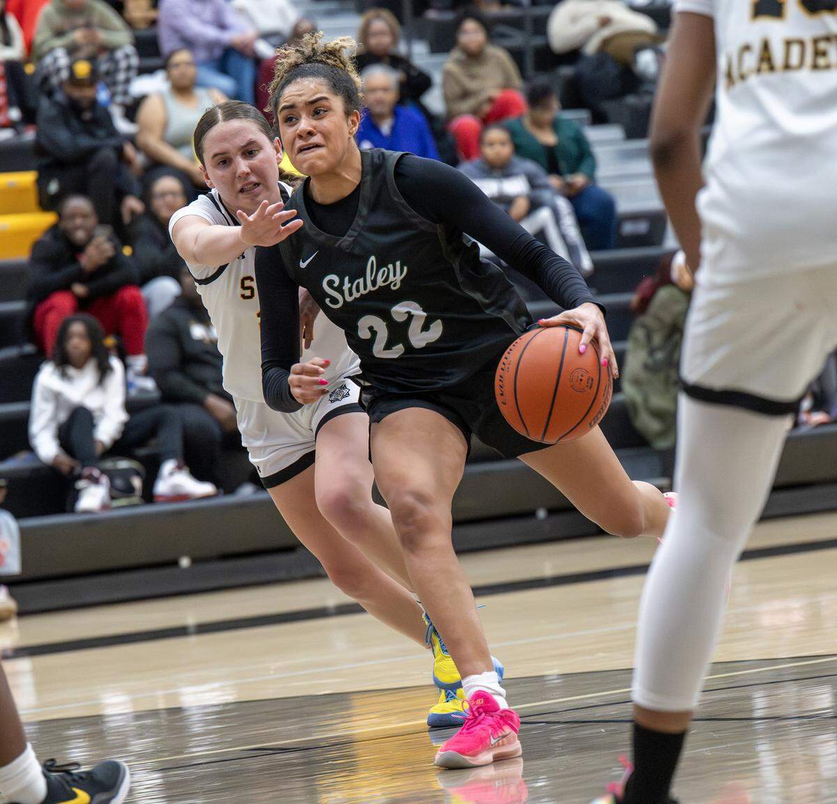 Brielle Mays dribbles the ball down the court as she tries to get past defenders during a basketball game at St. Teresa's Academy on Tuesday, Jan. 27, in Kansas City.