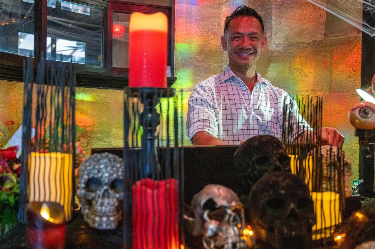 Tai Nguyen, co-owner of Cafe Trio, getting his restaurant ready for Halloween in 2023.