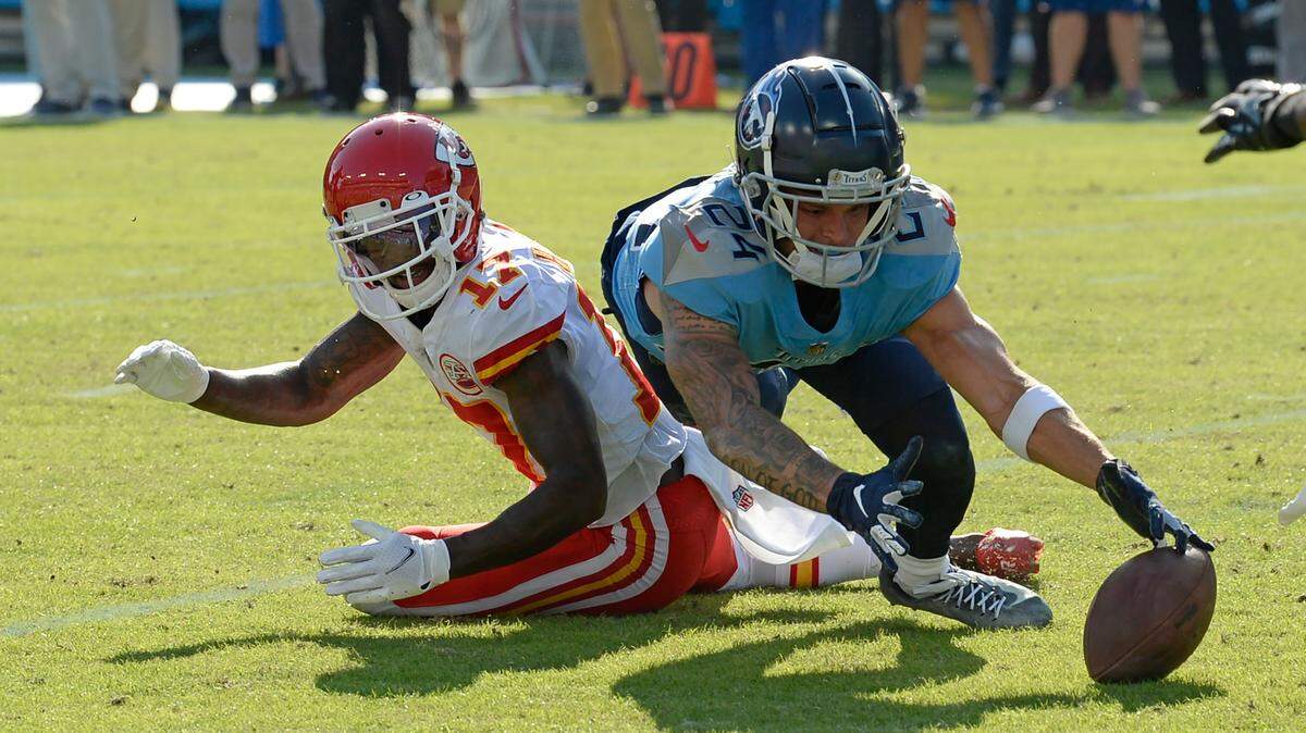 Kansas City Chiefs wide receiver Mecole Hardman (17) fumbles the ball as Tennessee Titans cornerback Elijah Molden (24) dives for it in the second half of an NFL football game Sunday, Oct. 24, 2021, in Nashville, Tenn. The Titans recovered the ball on the play. (AP Photo/Mark Zaleski)