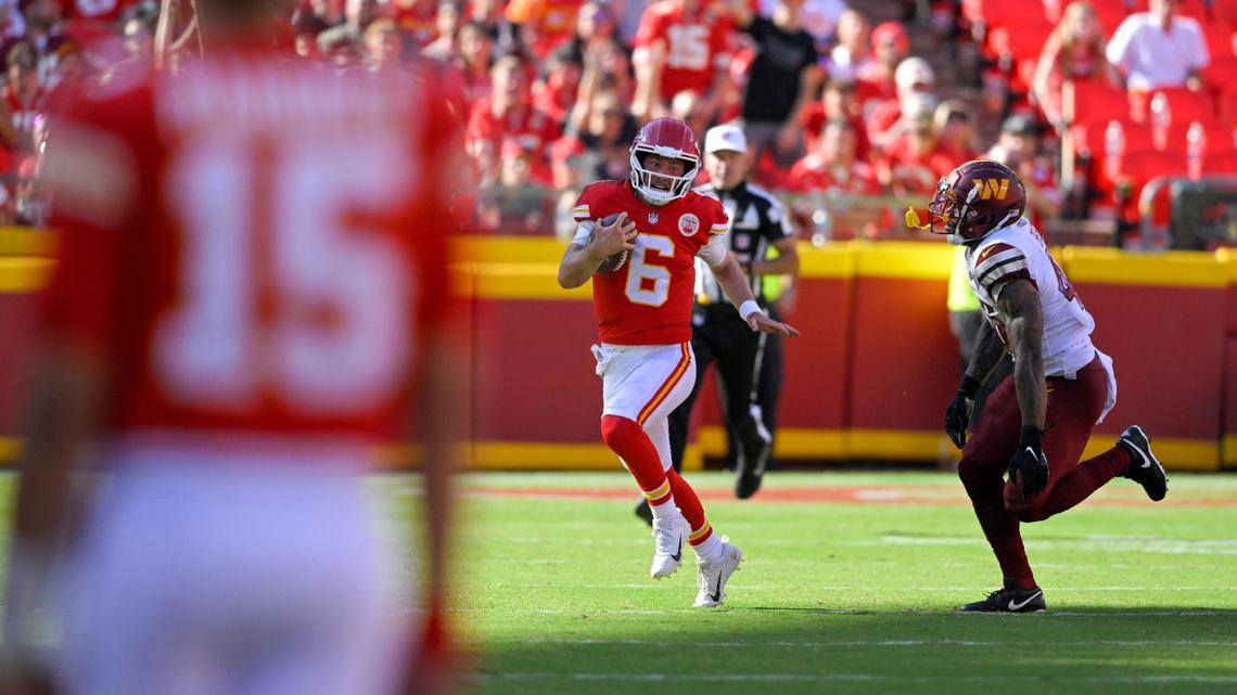 Kansas City Chiefs quarterback Patrick Mahomes looks on as backup quarterback Shane Buechele scrambles from Washington Commanders lineback Milo Eifler in the fourth quarter on Saturday, Aug. 20, 2022.