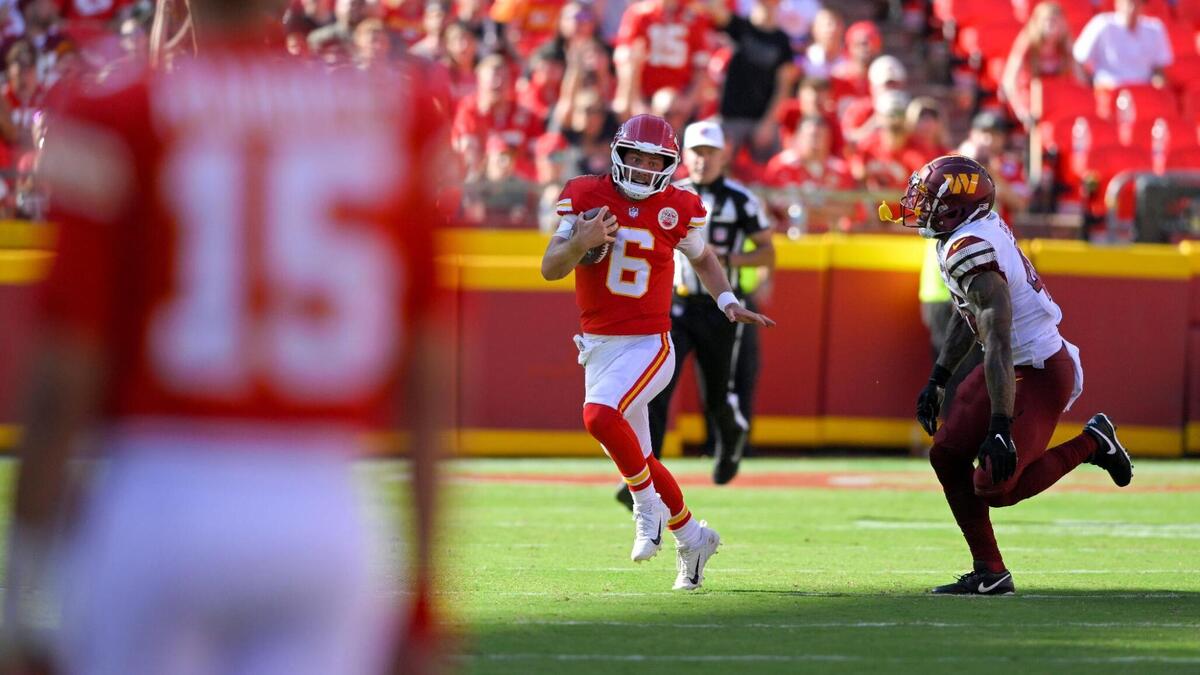 Kansas City Chiefs quarterback Patrick Mahomes looks on as backup quarterback Shane Buechele scrambles from Washington Commanders lineback Milo Eifler in the fourth quarter on Saturday, Aug. 20, 2022.