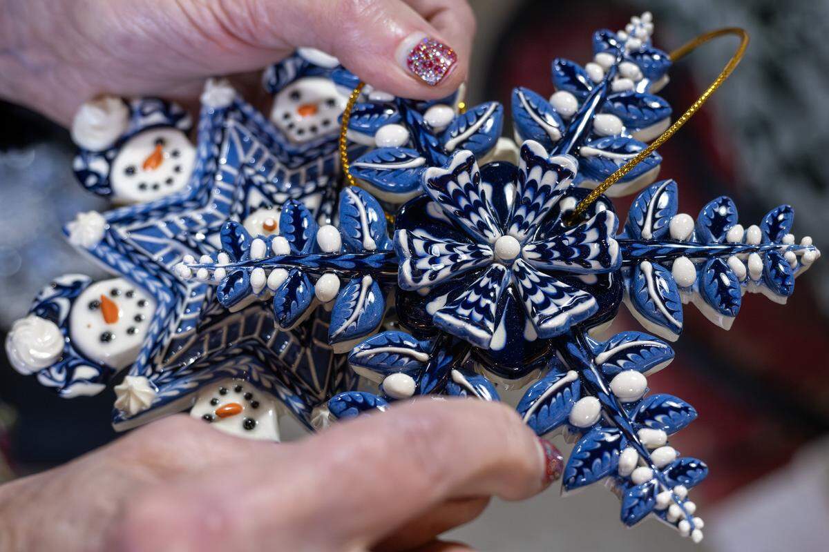 Ceramic artist Irma Starr points out details on one of her handmade ornaments inside her home studio on Thursday, Dec. 11, 2025, in Kansas City