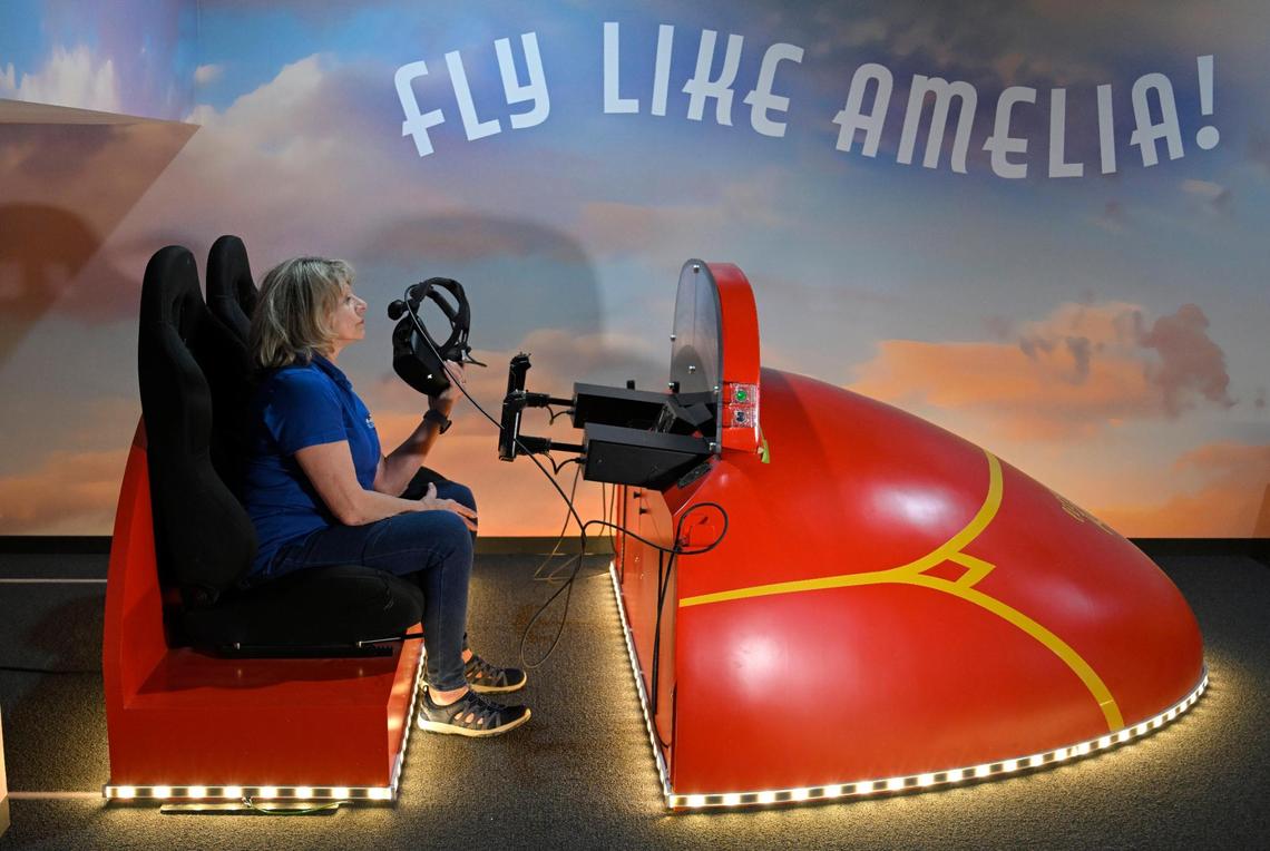 Karen Seaberg, the founder and president of the Atchison Amelia Earhart Foundation, prepares to don a virtual reality headset to experience Amelia Earhart’s 1932 transatlantic flight in an exhibit at the museum.
